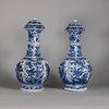 W750 Pair of Chinese blue and white ‘phoenix-head’ ewers and covers, Kangxi (1662-1722), of octagonal ogee-shaped section with ribbed necks, flaring rims and ornate phoenix-form spouts; the bulbous bodies