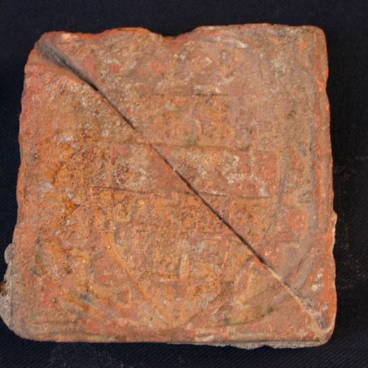N131 Medieval pottery floor tile, decorated with a shield