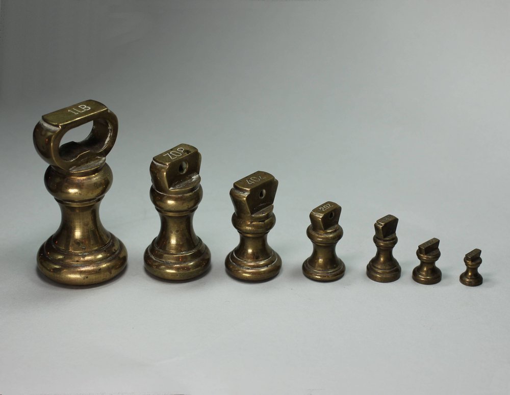 P235 Set of seven brass weights and weighing scales