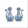 W750 Pair of Chinese blue and white ‘phoenix-head’ ewers and covers, Kangxi (1662-1722), of octagonal ogee-shaped section with ribbed necks, flaring rims and ornate phoenix-form spouts; the bulbous bodies