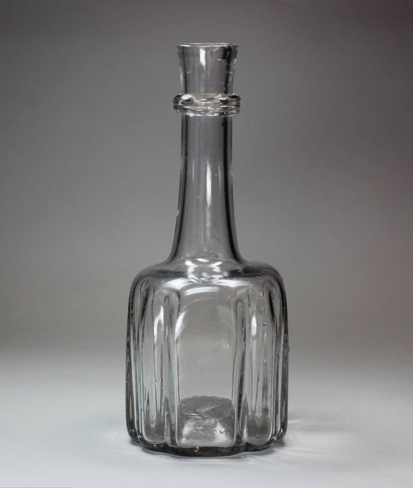 R986 An English cruciform-shape glass decanter, mould blown