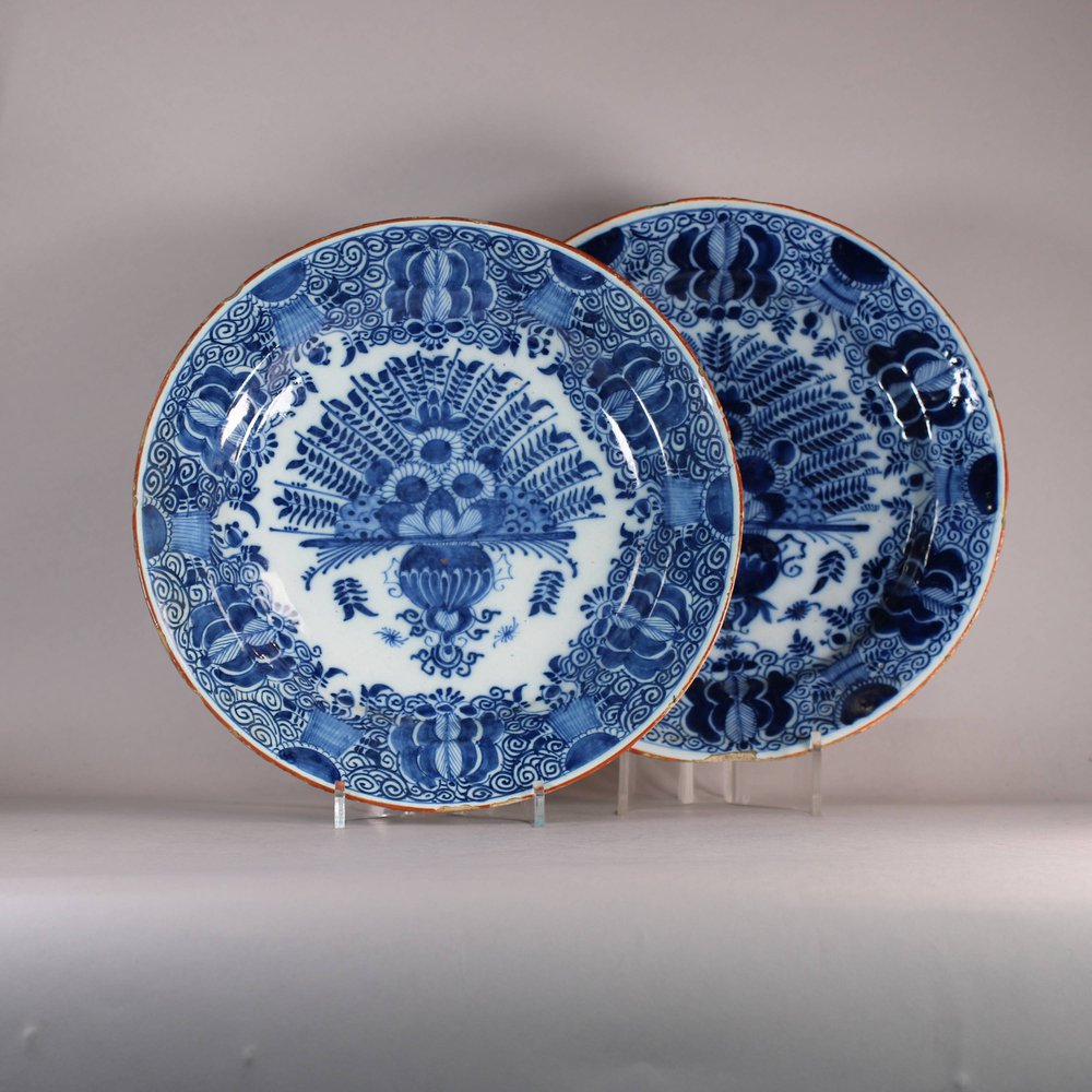 W497 Pair of Dutch Delft blue and white 'Peacock' chargers, 18th century, with underglaze blue axe on the base of one and the other with underglaze blue mark possibly of De Porceleyne Claeuw with the figur
