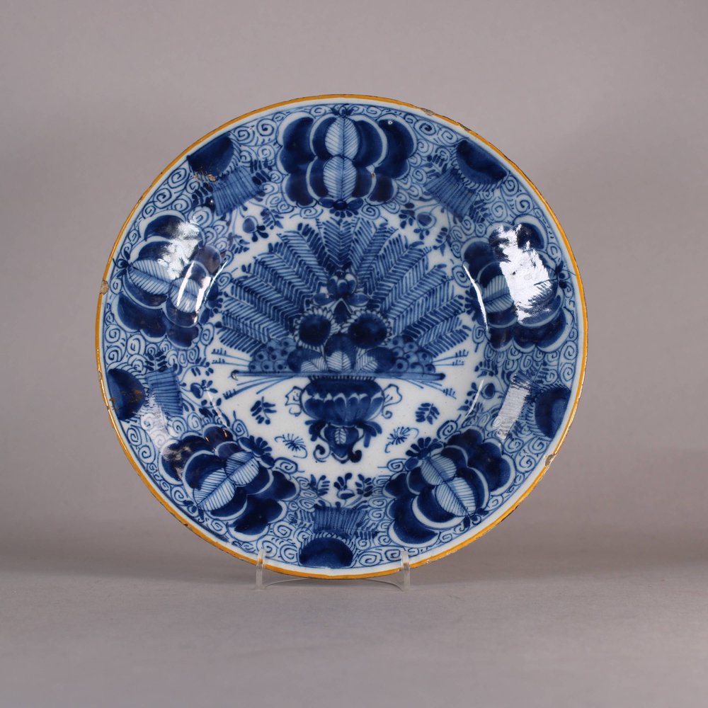 W503 Dutch delft blue and white 'Peacock' plate, 18th century,    with underglaze blue mark for    ? and I.A., diameter: 23.3cm. (9 1/8in.),condition: 2 small chips and some frit to ochre rim
