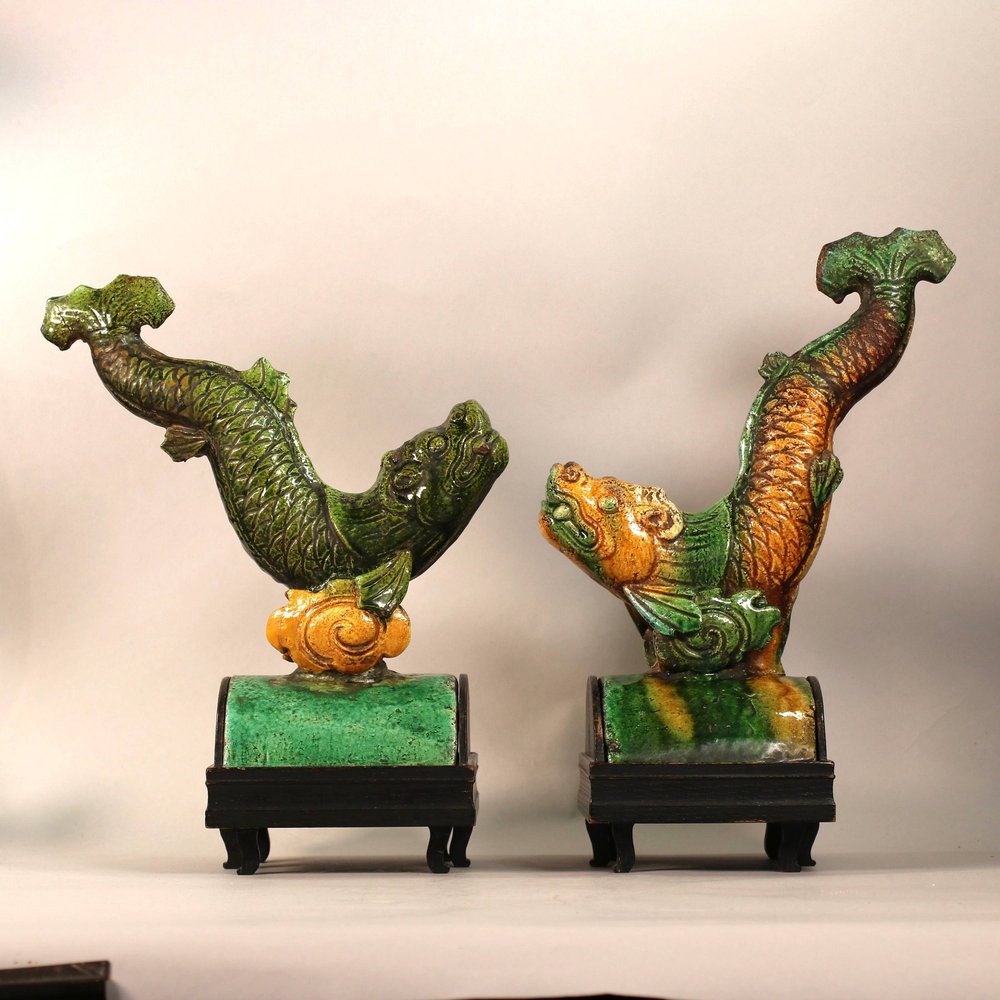 W990 Pair of MIng tile figures in the form of dynamic leaping carp in lead green and yellow glazed