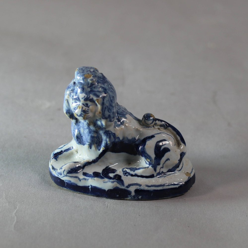 W993 Rare small Dutch delft blue and white figure of a recumbent lion