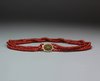 X824 Three strand coral bead choker with a filigree metal clasp