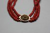 X824 Three strand coral bead choker with a filigree metal clasp