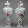 Y399 Pair of famille rose moulded vases and covers