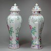 Y399 Pair of famille rose moulded vases and covers