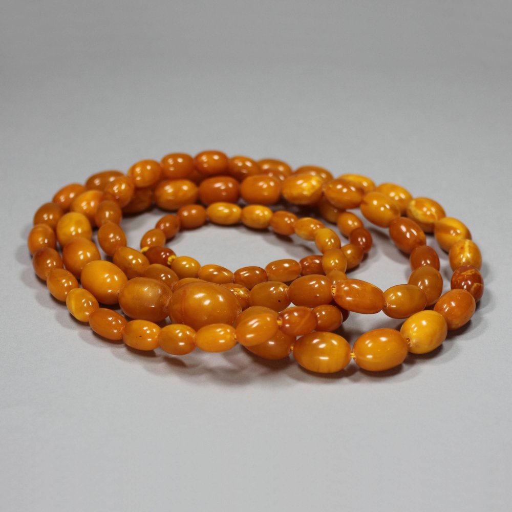 Y607 A long strand of graduated butterscotch amber beads