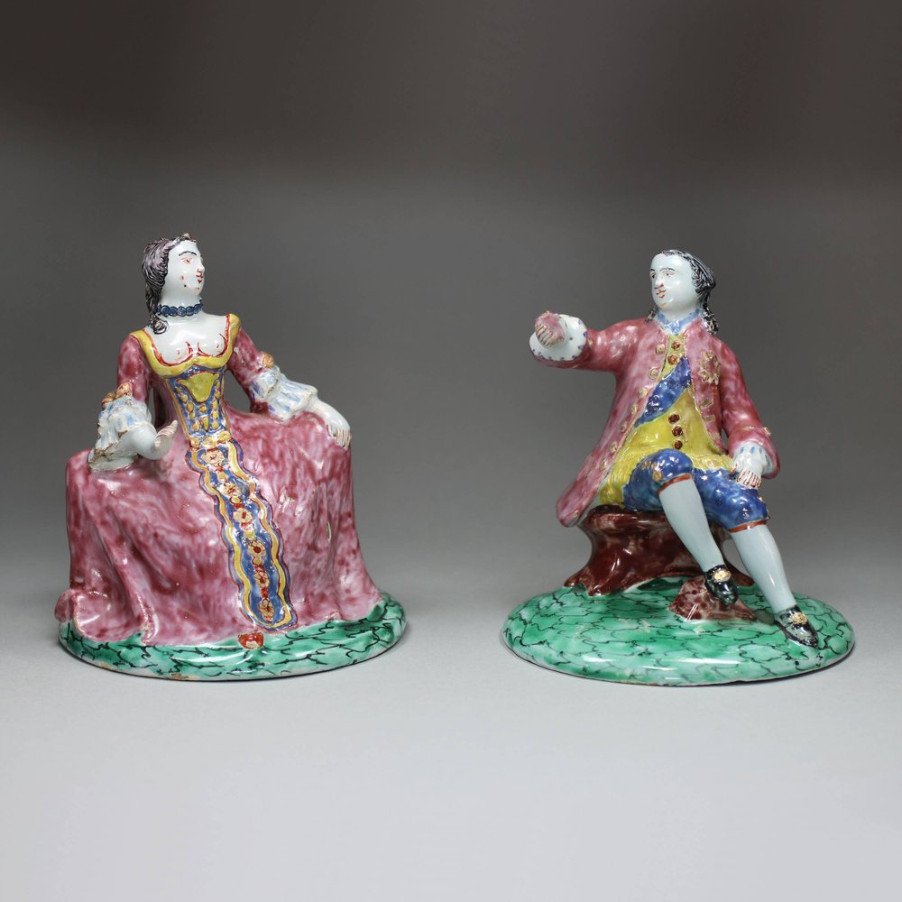 Y942 Pair of Delft polychrome figures of a seated man and woman