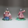 Y942 Pair of Delft polychrome figures of a seated man and woman