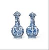 W750 Pair of Chinese blue and white ‘phoenix-head’ ewers and covers, Kangxi (1662-1722), of octagonal ogee-shaped section with ribbed necks, flaring rims and ornate phoenix-form spouts; the bulbous bodies